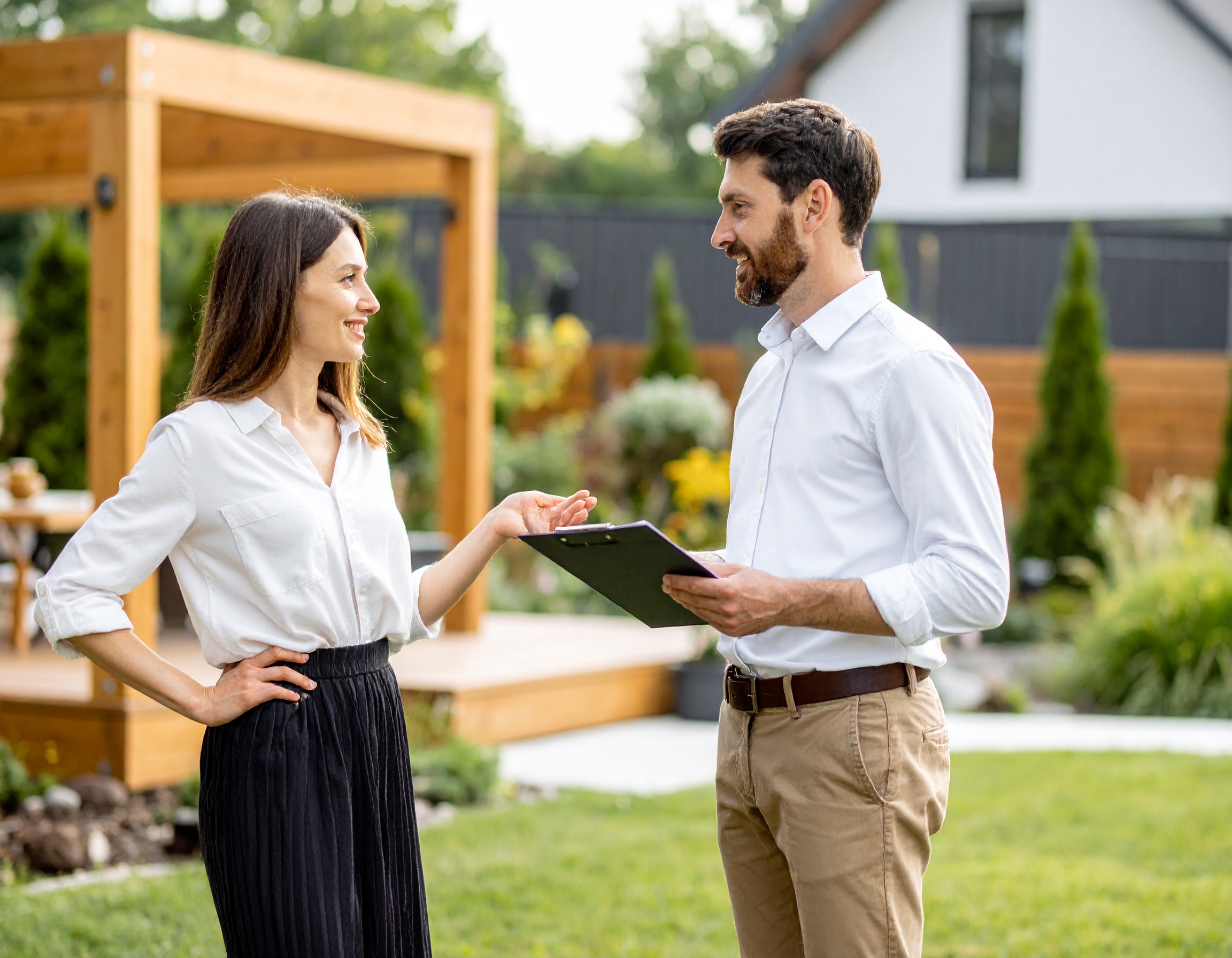 A home adviser reviewing recurring property-service details with a homeowner.